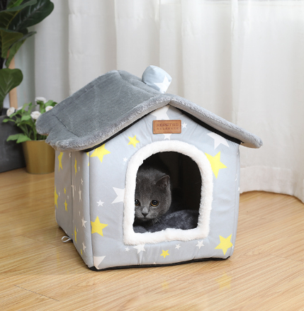 The Nook cozy plush cat house with a cat resting inside